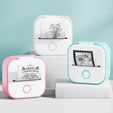 Mini thermal printers in pink, blue, and white displaying black and white printed designs