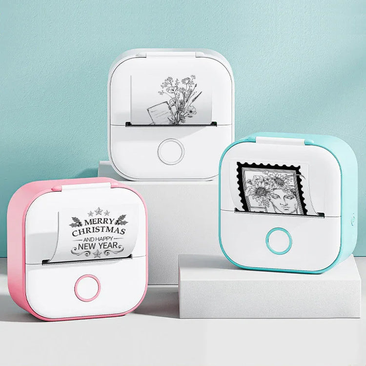 Mini thermal printers in pink, blue, and white displaying black and white printed designs