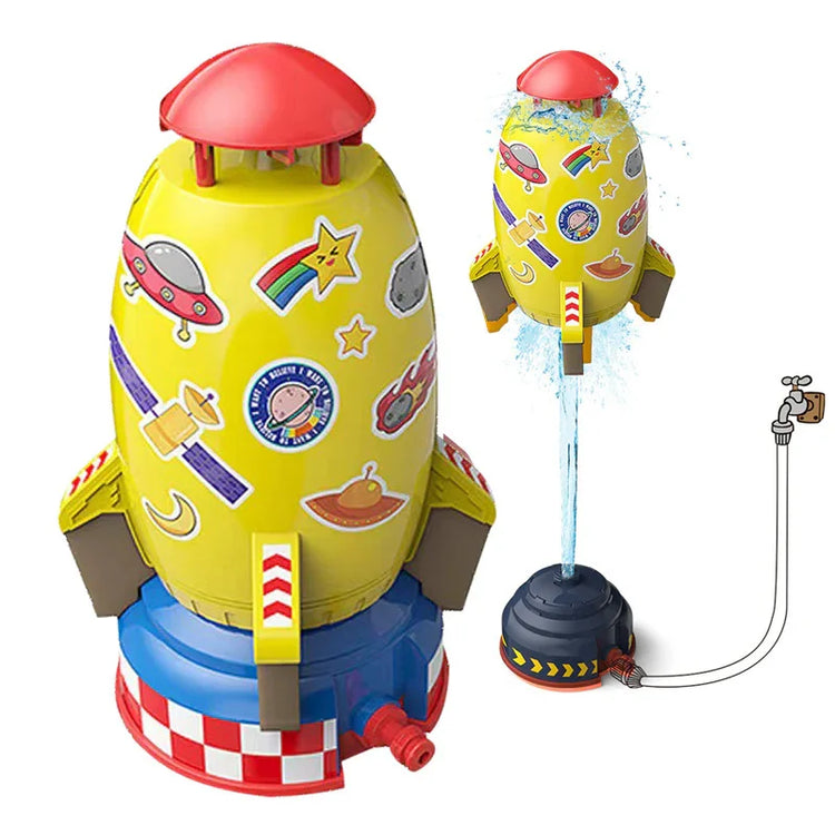 Yellow rocket-shaped sprinkler toy with colorful space stickers, water spraying feature