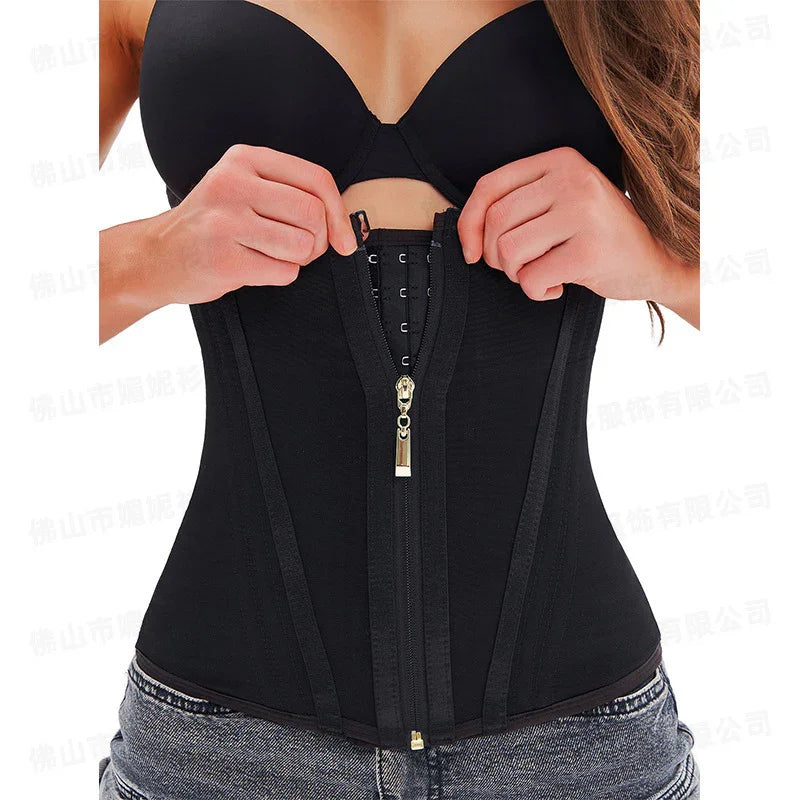 Woman wearing black waist trainer corset with zipper closure, fitted shapewear over jeans