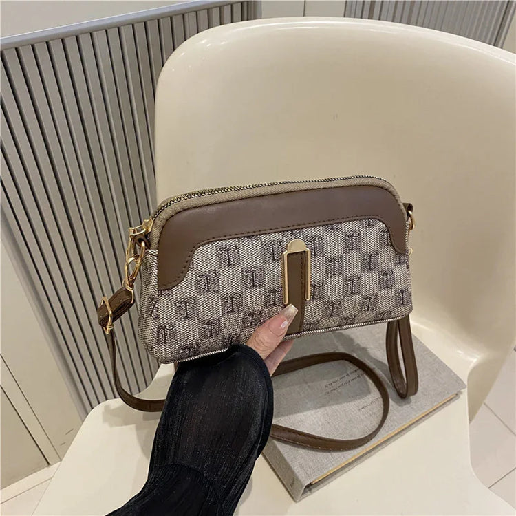 Beige and brown crossbody bag with geometric pattern, faux leather trim, compact fit