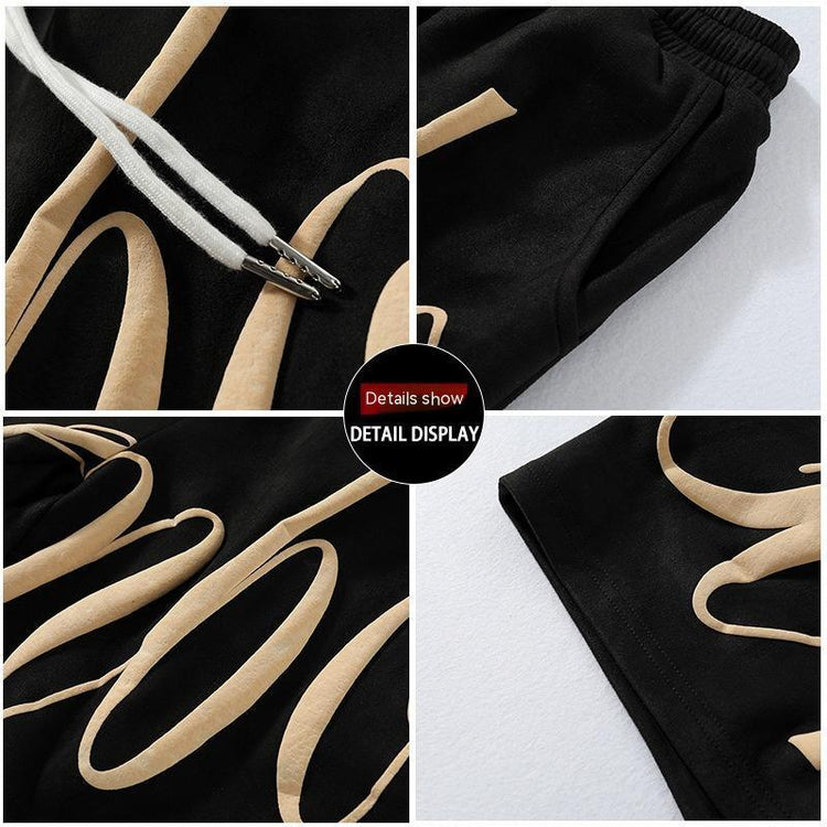 Black sweatpants with beige graphic print, elastic waistband, metal-tipped drawstrings, relaxed fit