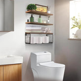 Modern bathroom with floating wooden shelves, folded towels, toiletries, and toilet paper storage.