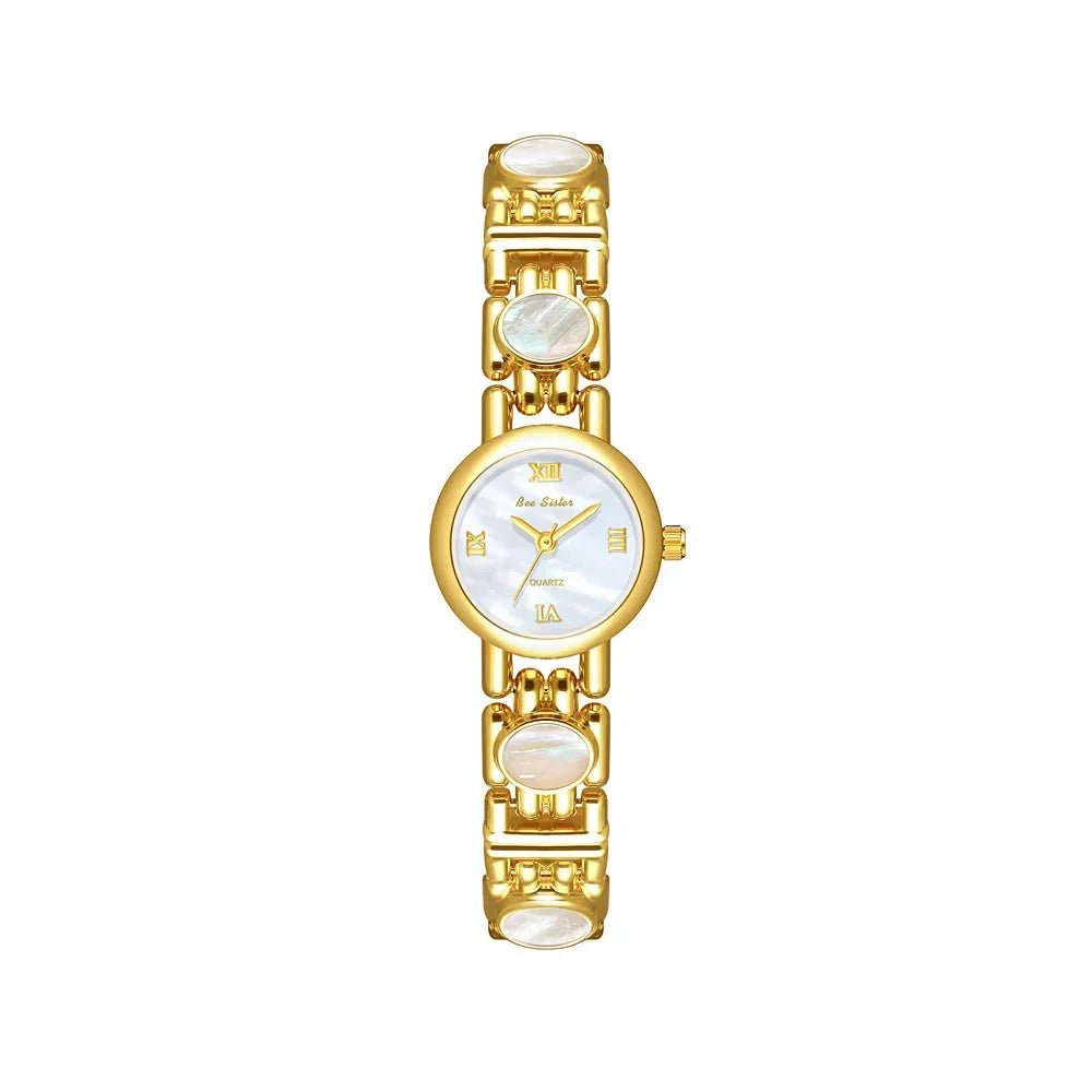 Gold tone women's watch with white mother of pearl face and oval bracelet accents