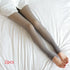 Gray sheer tights with smooth slim fit, worn on legs, shown on white bedding