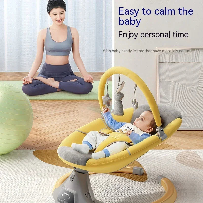 Woman in gray sports bra and high-waist leggings, seated on a mat, baby in a yellow cushioned rocker.