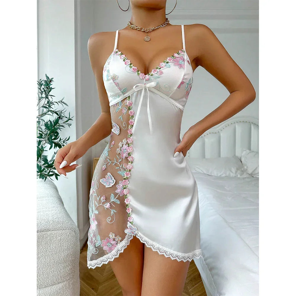 White satin slip dress with floral lace embroidery, sheer mesh panel, and slim fit
