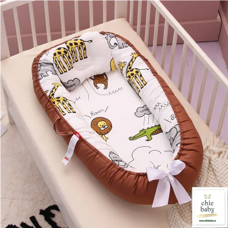 Plush baby nest with brown edge, white interior, cartoon animal print, placed in crib