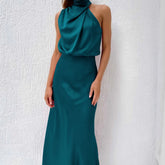 Sleeveless teal satin halter dress with draped neckline and slim fit, elegant evening style
