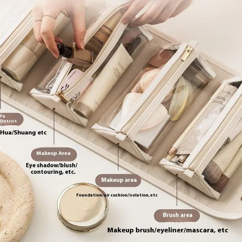 Beige multi-compartment cosmetic bag with clear zip pouches for makeup and brushes.