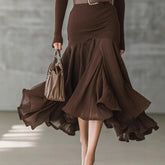 Brown ribbed long-sleeve top and flowy, high-waist pleated skirt, fitted silhouette