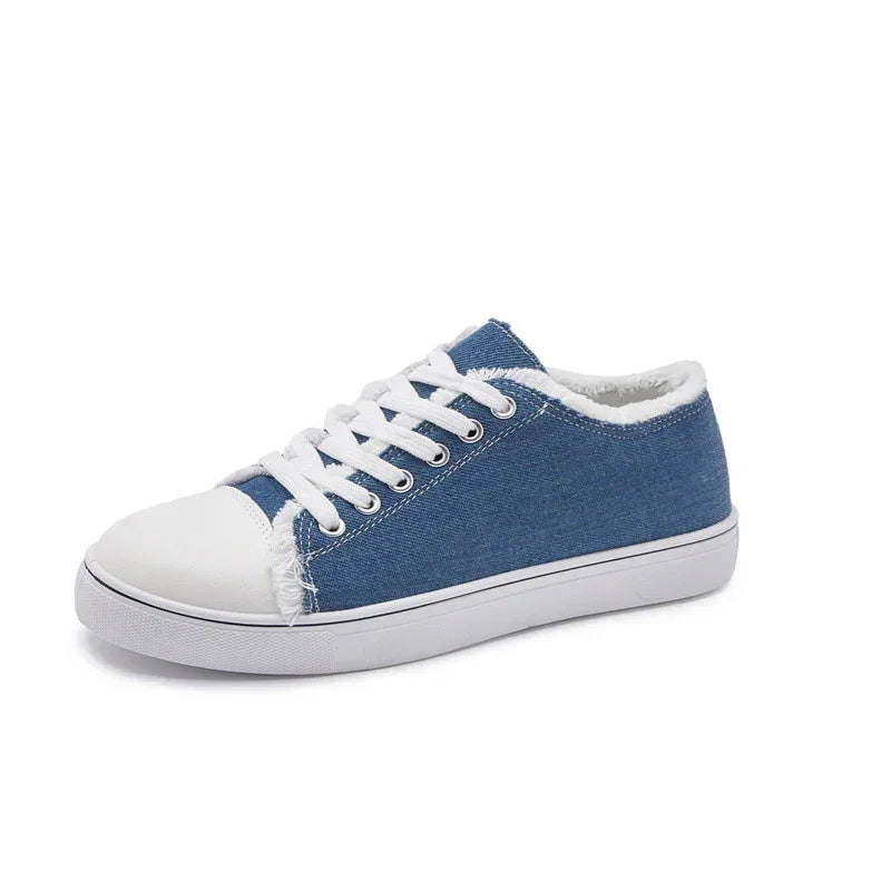 Blue denim low top sneaker with white rubber sole and laces, casual street style