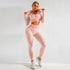 Woman in peach and white seamless textured two-piece workout set, zip hoodie and leggings