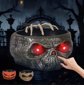 Halloween skull candy bowl with glowing red eyes, creepy hand decoration, spooky design
