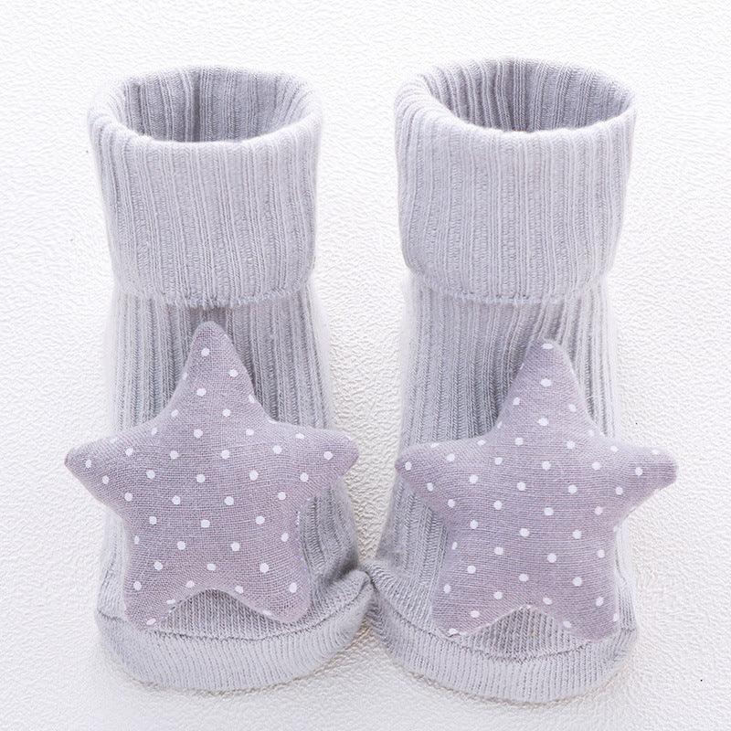 Grey ribbed baby socks with soft fabric star and polka dot accents, cozy fit.