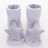 Grey ribbed baby socks with soft fabric star and polka dot accents, cozy fit.