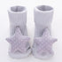 Grey ribbed baby socks with soft fabric star and polka dot accents, cozy fit.