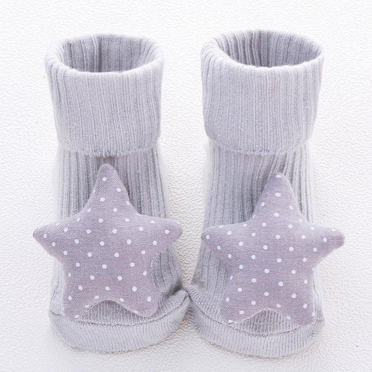 Grey ribbed baby socks with soft fabric star and polka dot accents, cozy fit.