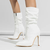 White patent leather stiletto heeled boots with a slouchy fit and side zipper