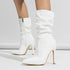 White patent leather stiletto heeled boots with a slouchy fit and side zipper