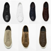 Assorted low-top sneakers in black, white, navy, brown leather and beige, tan, brown suede, minimalist design.
