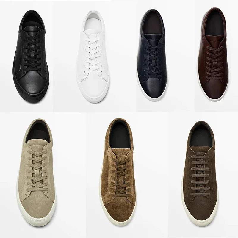 Assorted low-top sneakers in black, white, navy, brown leather and beige, tan, brown suede, minimalist design.