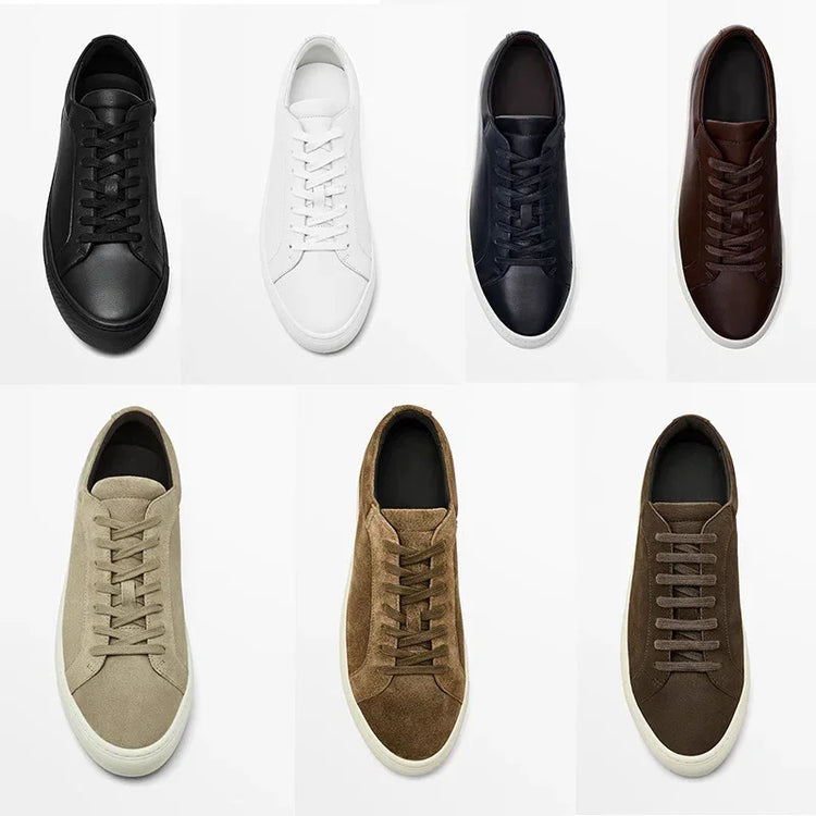 Assorted low-top sneakers in black, white, navy, brown leather and beige, tan, brown suede, minimalist design.