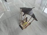 Wooden mechanical model of a manta ray with gear mechanism on light marble floor