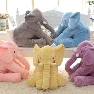 Plush elephant toys in pastel pink, yellow, gray, blue, and purple on a white carpet