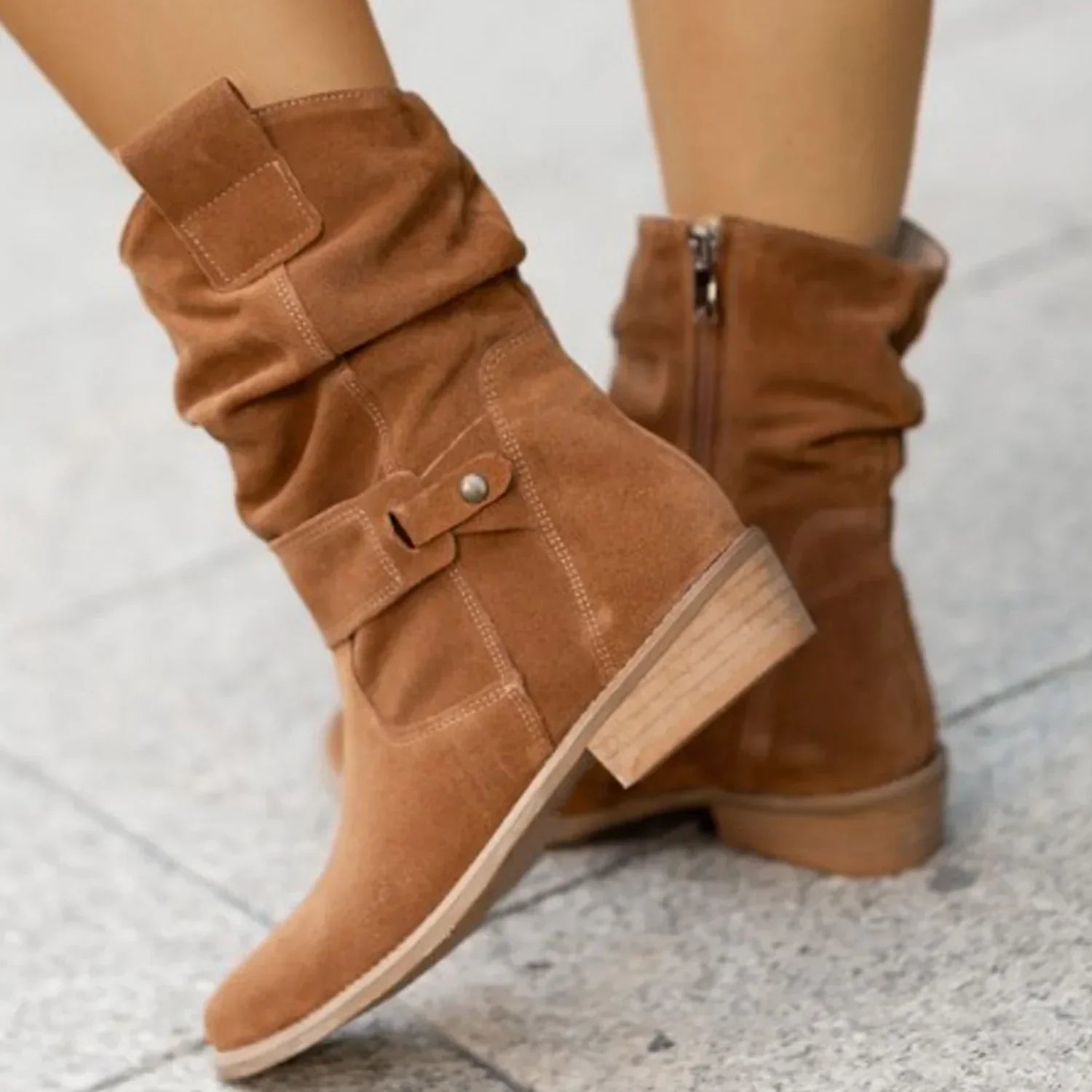 Brown suede mid-calf boots with slouchy fit and low block heel, street style.