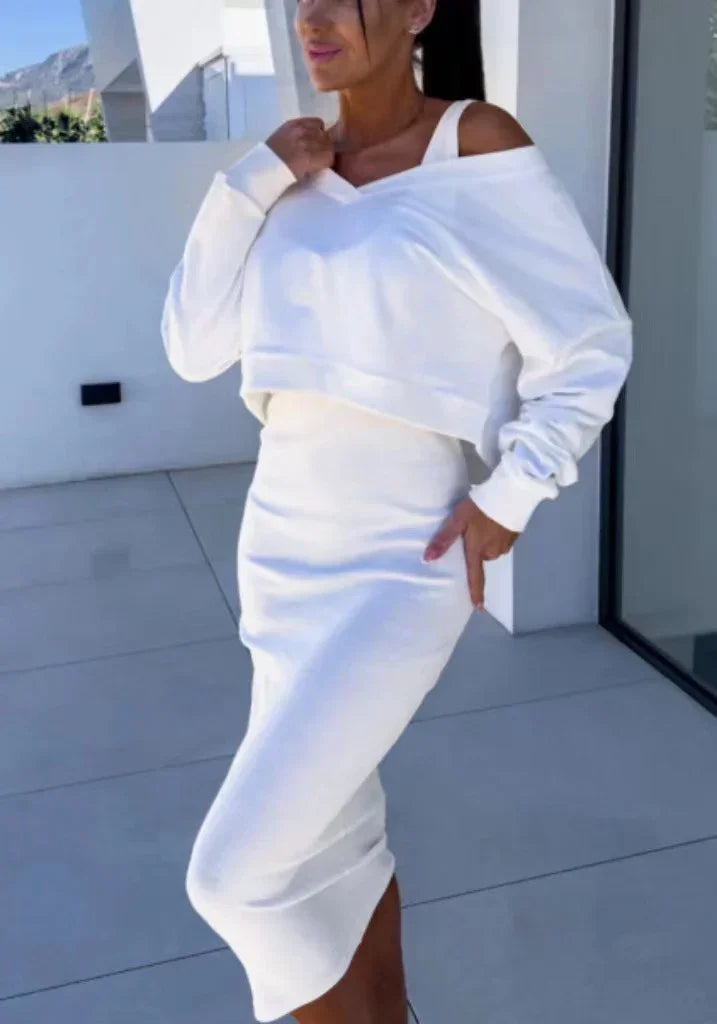 Woman wearing a white off-shoulder cropped sweatshirt with matching fitted midi skirt, modern fit
