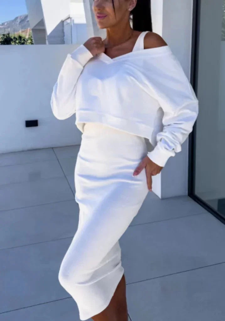 Woman wearing a white off-shoulder cropped sweatshirt with matching fitted midi skirt, modern fit