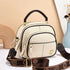 Cream faux leather crossbody bag with gold zippers, brown adjustable strap, structured fit