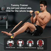 Man wearing black athletic shorts using resistance bands for full body workout, seated on gym mat.