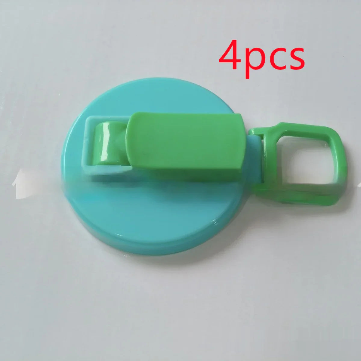 Blue and green plastic clip with a flat round base, lightweight and compact design