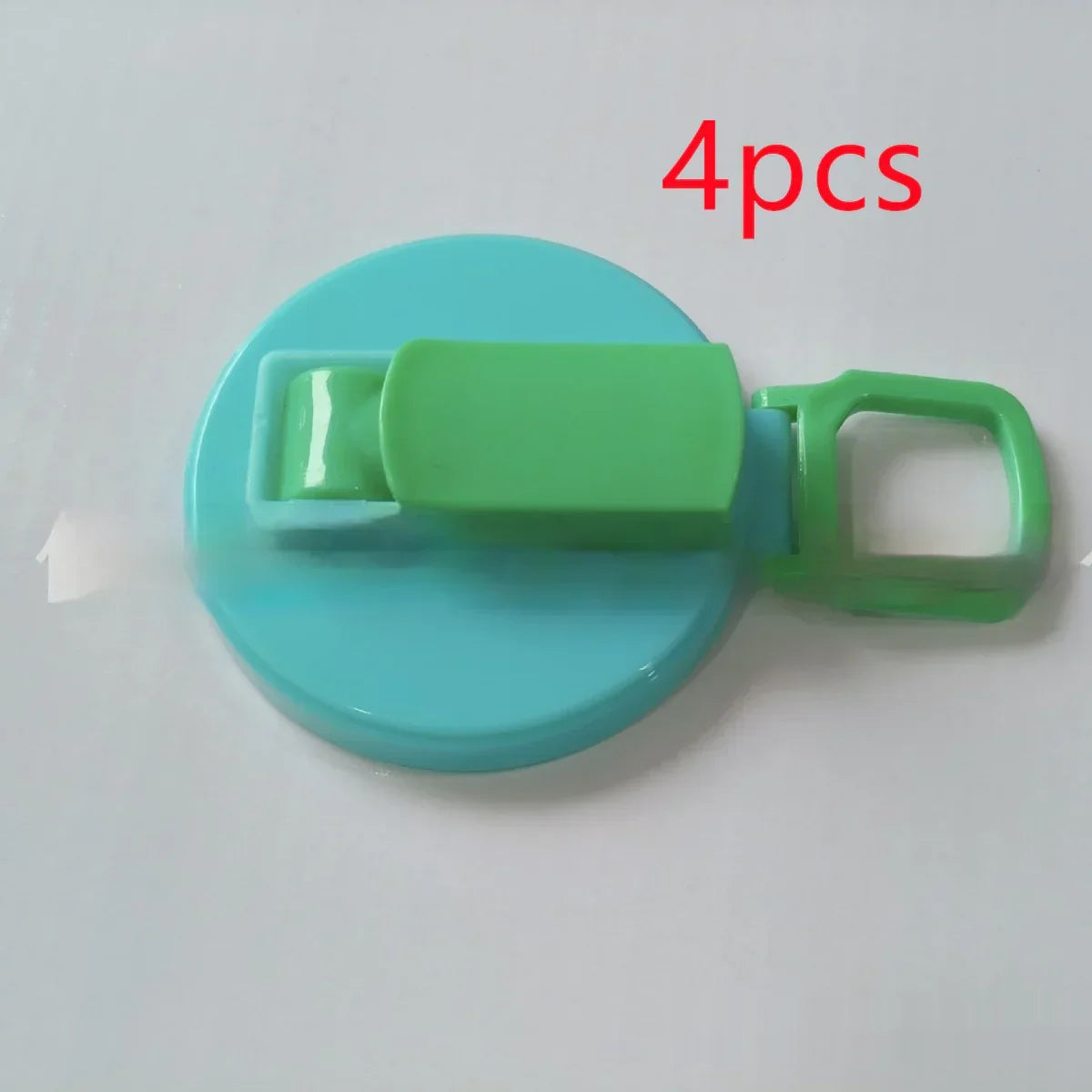 Blue and green plastic clip with a flat round base, lightweight and compact design