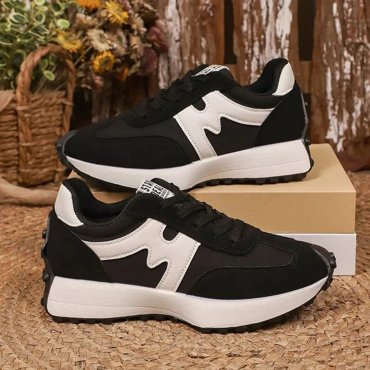 Black and white suede sneakers with chunky sole, modern streetwear style, casual fit