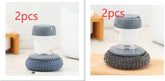 Set of two dish scrubbers with grey handles and steel mesh cleaning pads on kitchen counter
