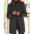 Woman wearing a dark gray wool coat with a tailored fit and flap pockets.
