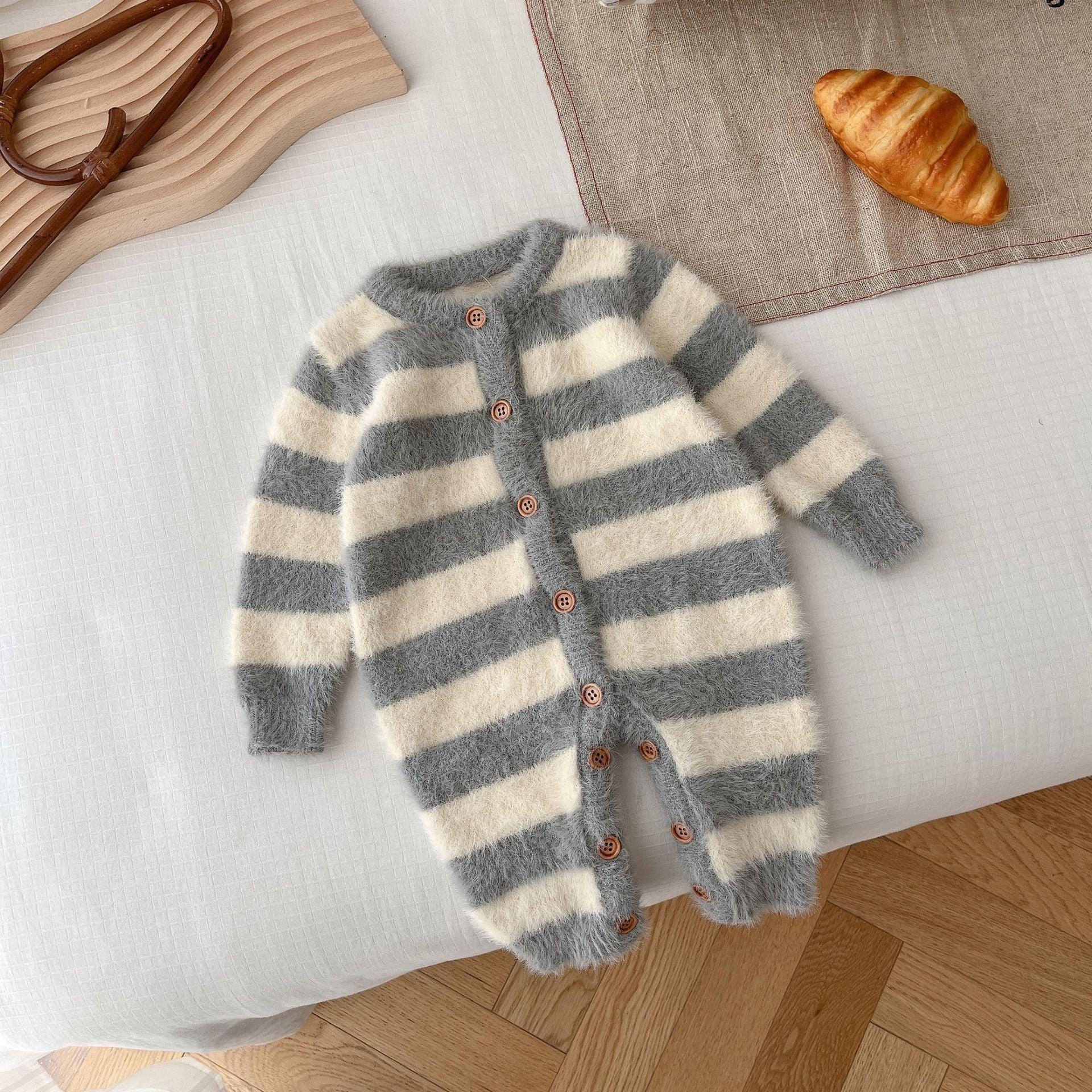 Fuzzy gray and white striped baby romper with long sleeves and wooden buttons, laid flat