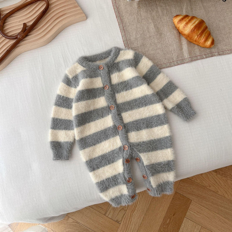 Fuzzy gray and white striped baby romper with long sleeves and wooden buttons, laid flat