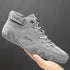 Gray suede high-top sneaker with lace-up front and secure strap, minimalist streetwear style