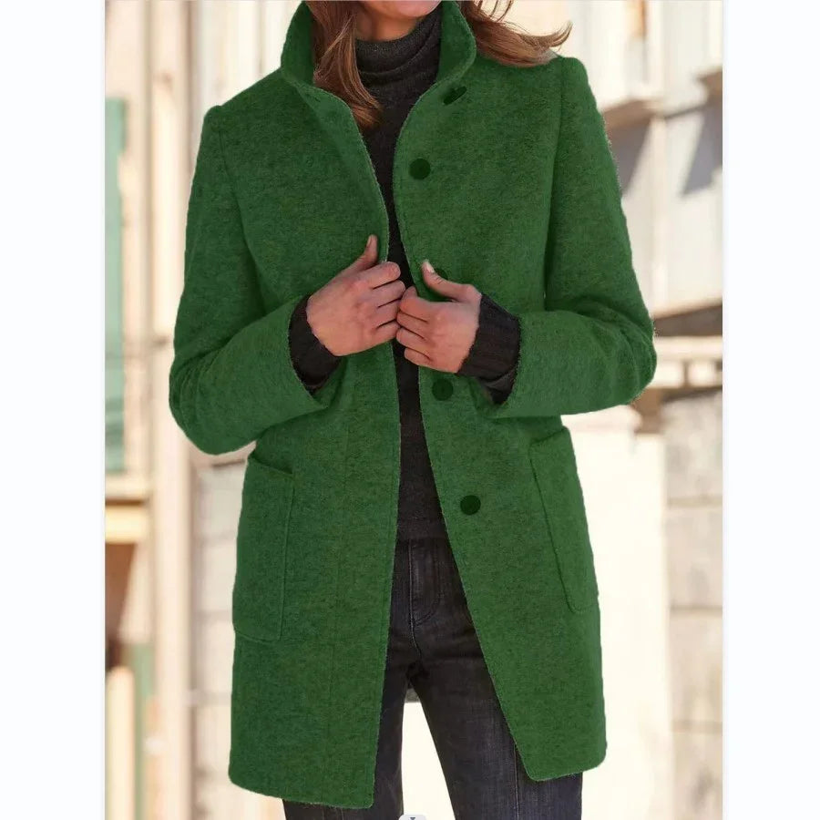 Woman wearing a green wool coat, buttoned front, pocket detail, relaxed fit, street style