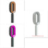 Three oval-shaped hair brushes in brown, pink, and white, with ergonomic handles and sleek modern design.