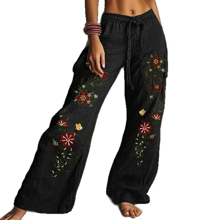 Black wide-leg drawstring pants with colorful floral embroidery, relaxed fit, lightweight fabric