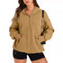 Woman wearing oversized tan quarter-zip hoodie with front pocket and black shorts, casual streetwear style