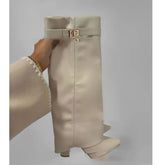 Beige knee-high leather boot with gold buckle, chunky heel, and minimalist style