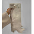 Beige knee-high leather boot with gold buckle, chunky heel, and minimalist style
