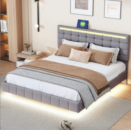 Modern bedroom with upholstered gray platform bed, white bedding, and tan accent blankets