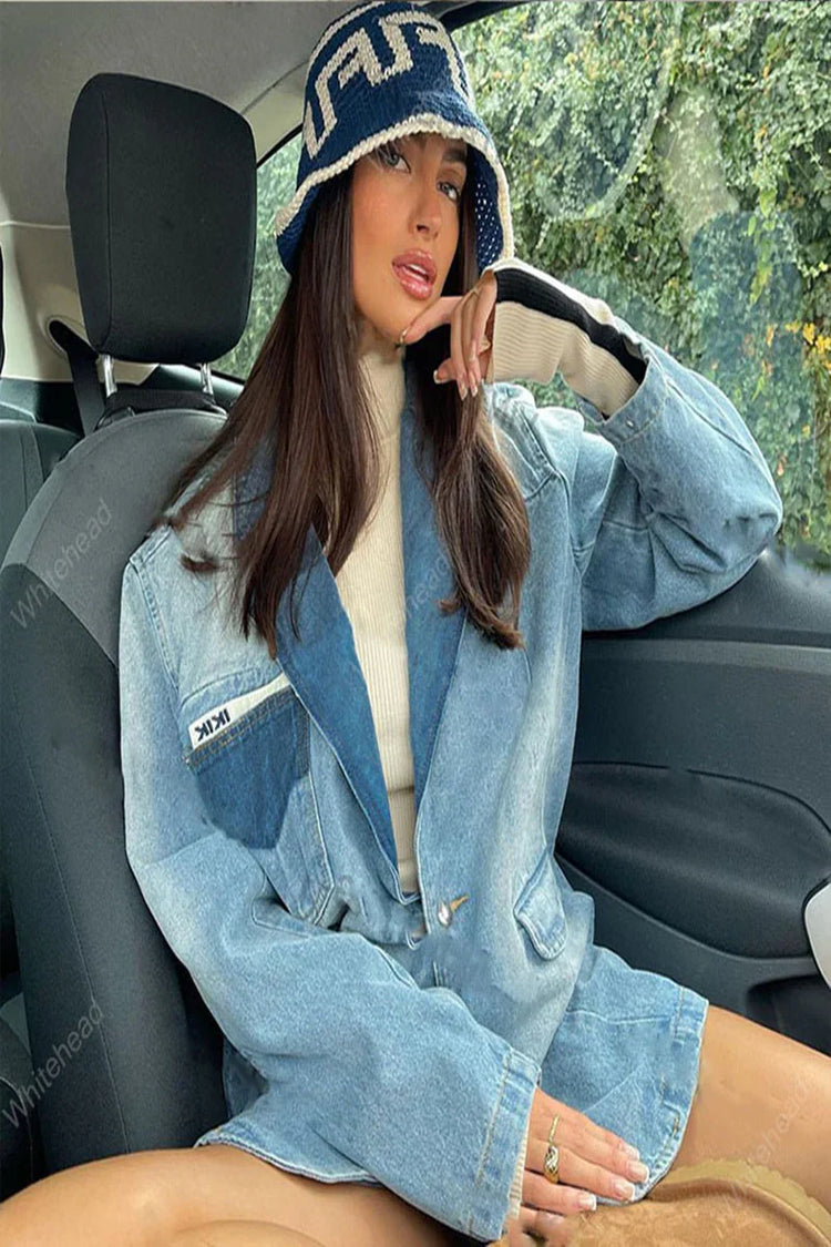 Woman in oversized light blue denim jacket and bucket hat, wearing a beige turtleneck sweater.
